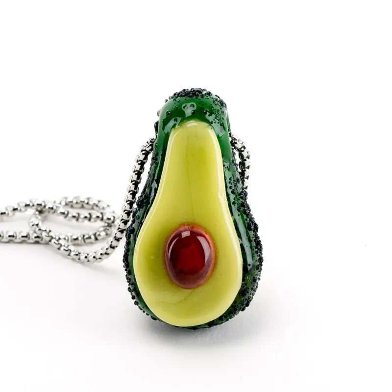 Avocadope pendant glass hand pipe by Empire Glassworks: vibrant green yellow avocado halved with red center on silver chain