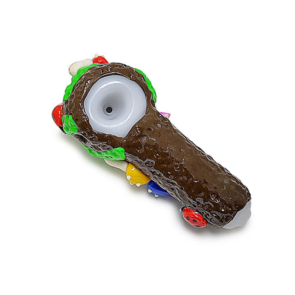 Brown tree-shaped glass pipe featuring clay ladybug mushroom and ladybug mushroom crystals