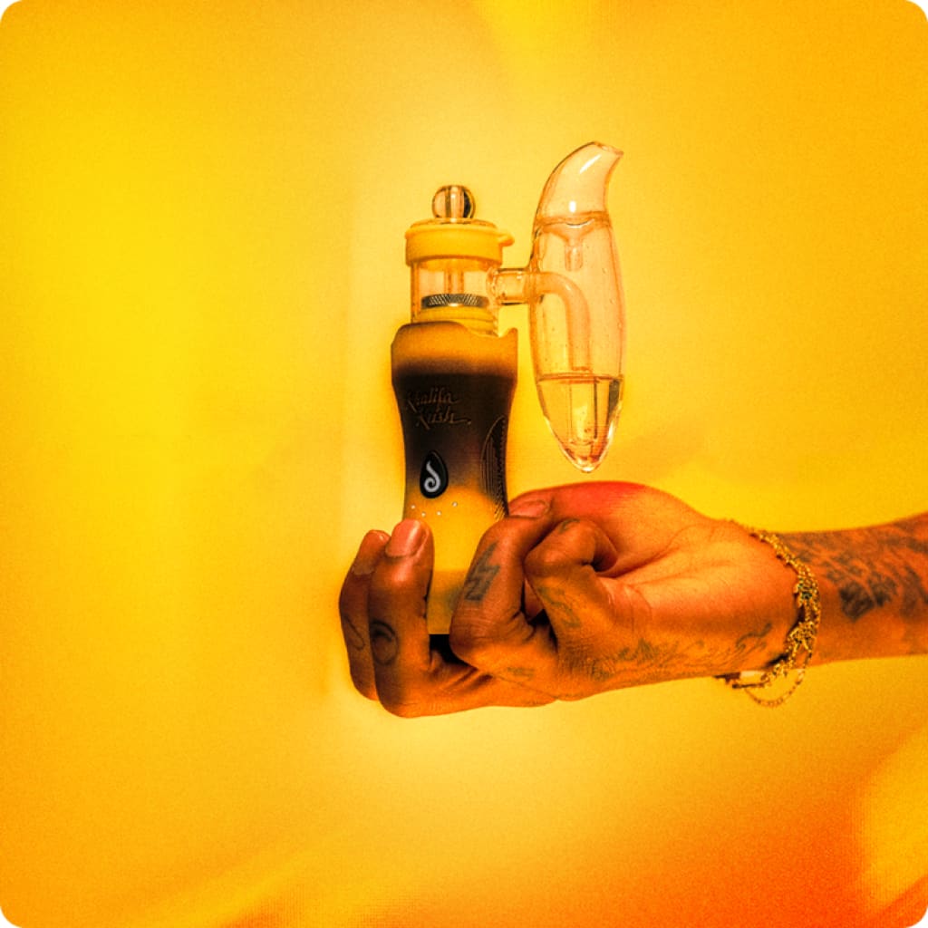Tattooed hand holding yellow Khalifa Kush Edition water bottle with a curved transparent attachment