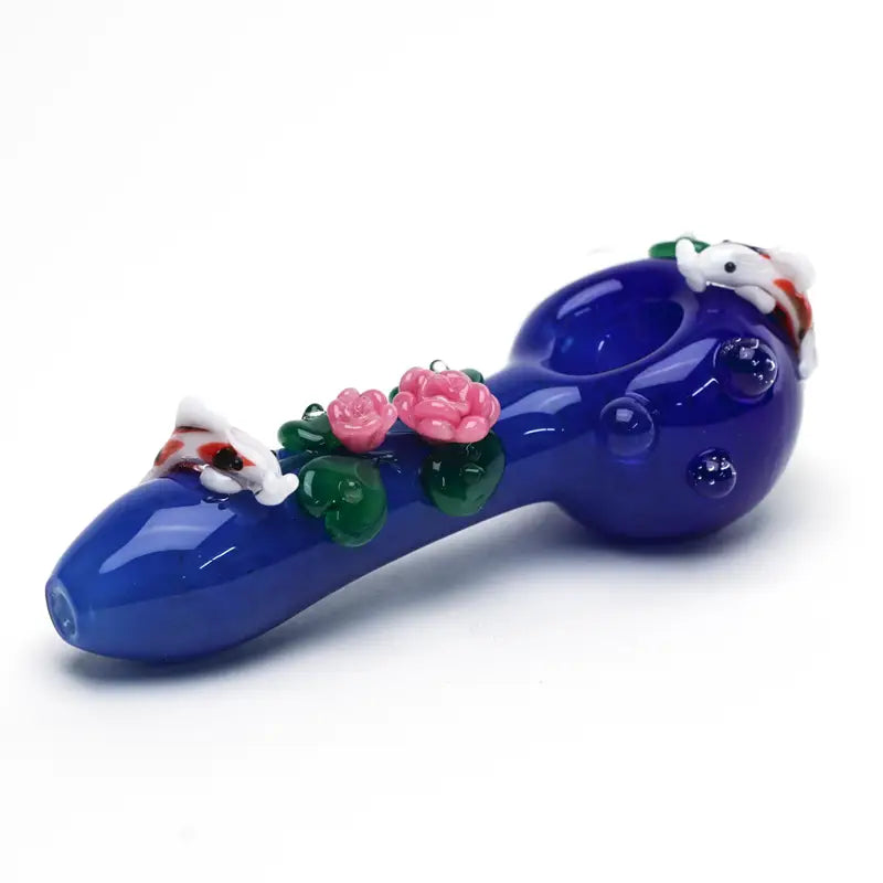 Empire Glassworks koi pond spoon pipe with cobalt blue glass, pink roses, green leaves, and white koi fish