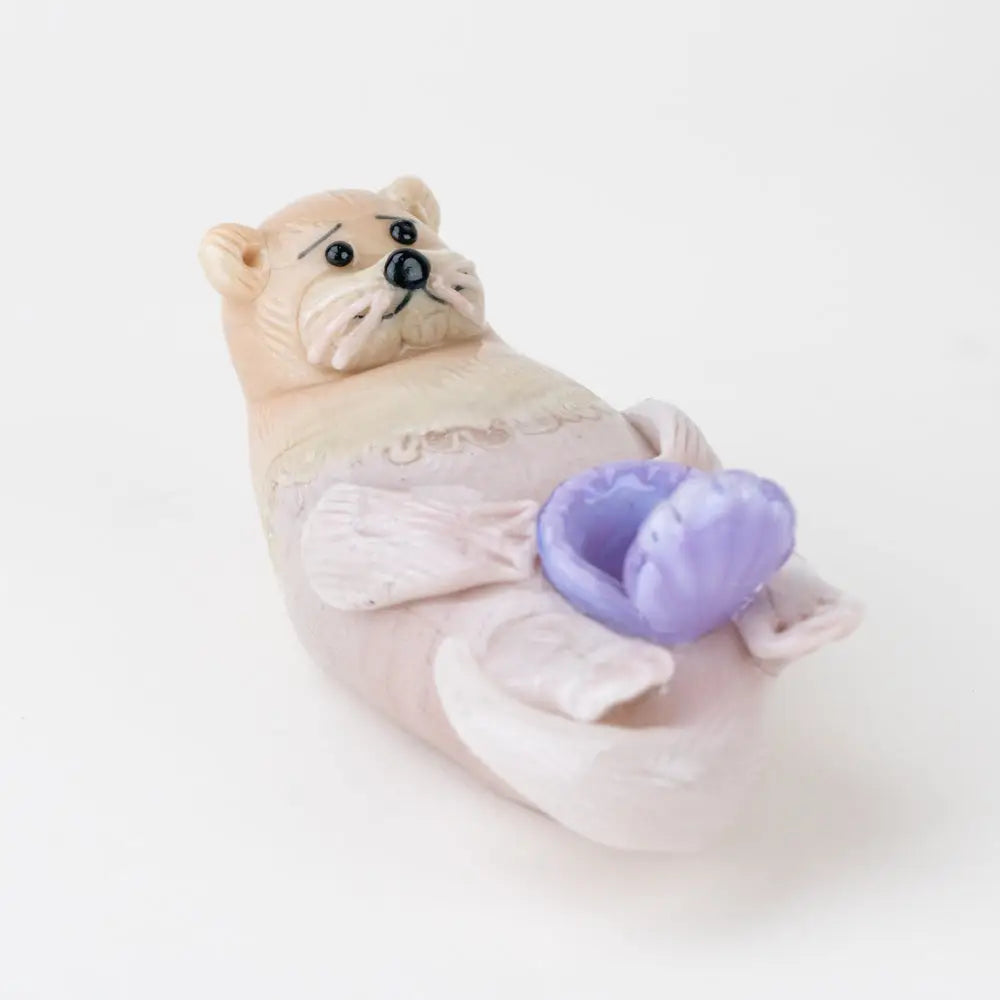 Pastel pink Empire Glassworks otter glass hand pipe with purple seashell