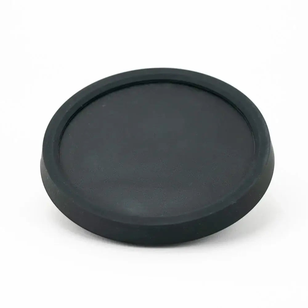 Black circular rubber lens cap on Empire Glassworks Peak Attachment Display Stand