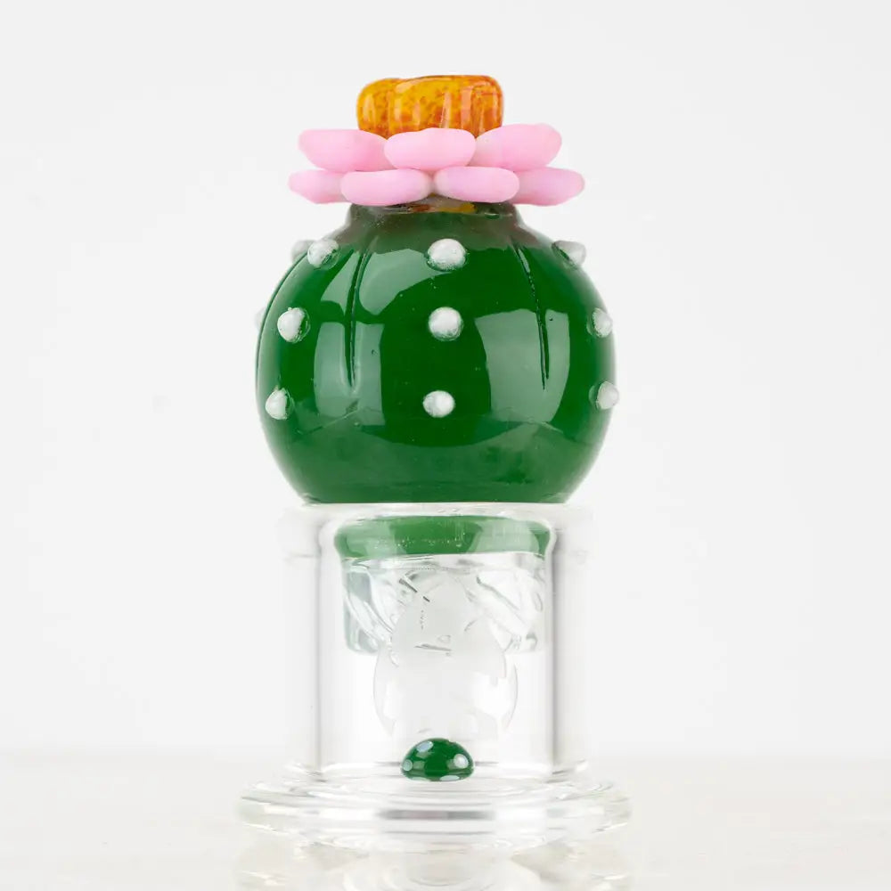 Empire Glassworks Peyote Spinner Carb Cap: vibrant green glass cactus pipe with pink flower top on clear base