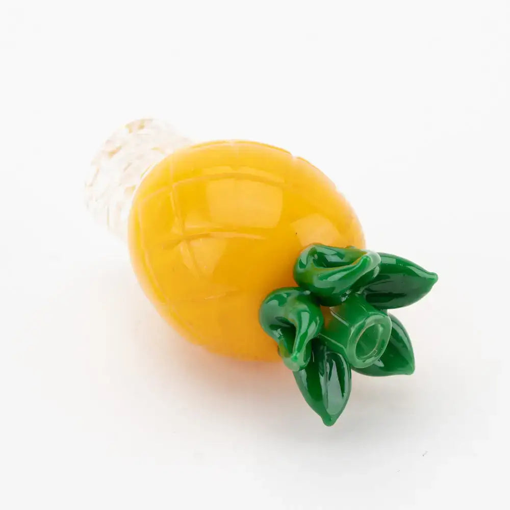 Empire Glassworks pineapple themed carb cap in vibrant yellow glass with green leaf accents