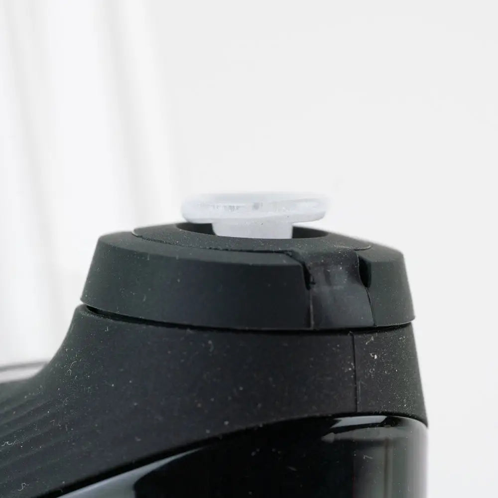 Black speckled Empire Glassworks Proxy Glass Joystick glow in the dark water bottle with translucent white cap