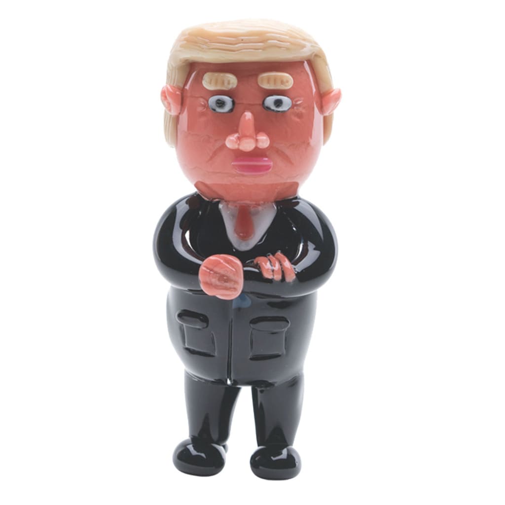 Cartoon-style man in black suit, blonde hair – Agent Orange Spoon Pipe by Empire Glassworks