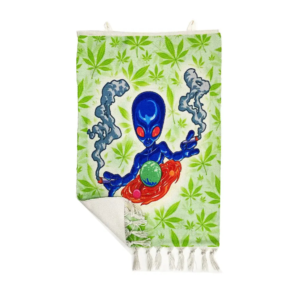 Light green tapestry with marijuana leaves and a smoking blue alien on cosmic alien glass pipe