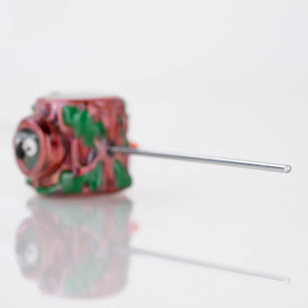 Hooties Forest poker wand by Empire Glassworks: red and green intricately carved camera-shaped bead with metallic needle