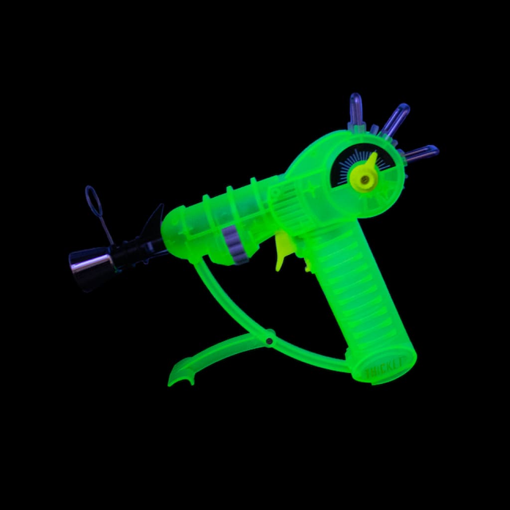 Glow In The Dark Real Life Ray Gun Torch: Bright green toy with purple accents on black backdrop