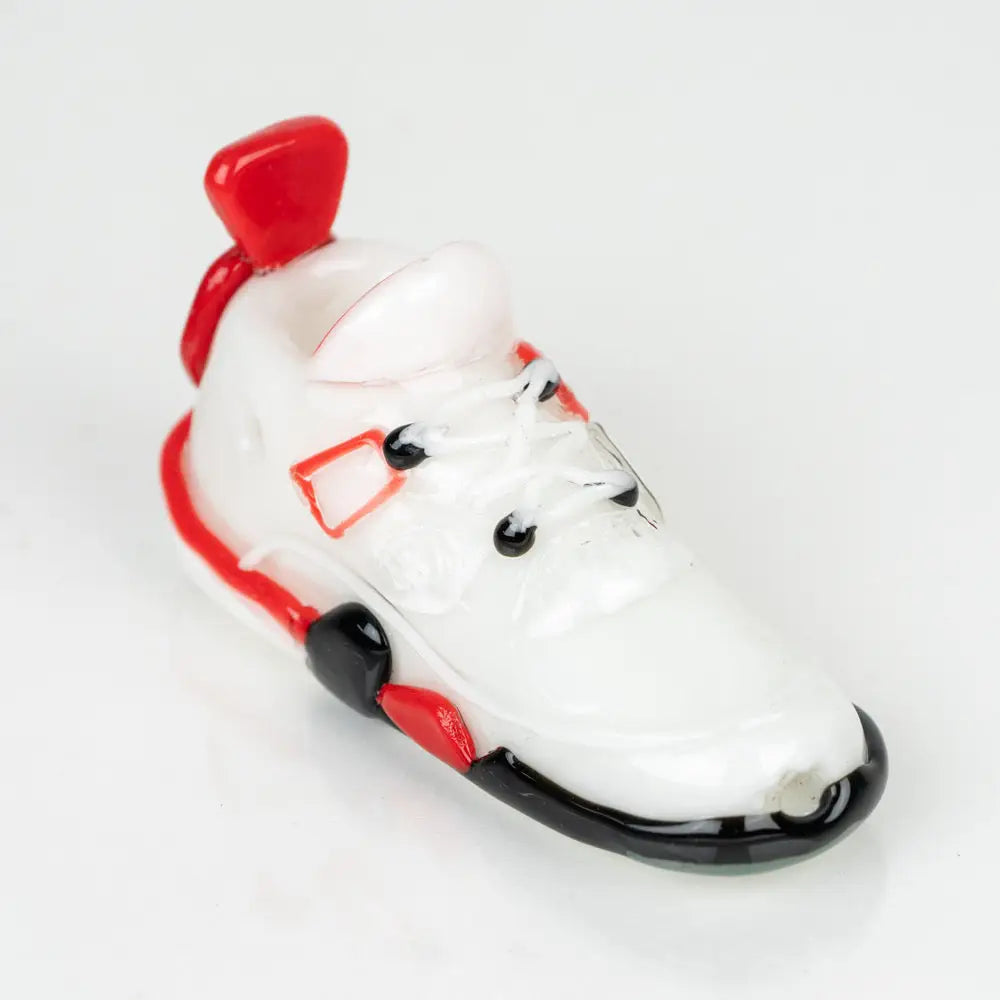 Miniature white sneaker with red and black accents on Retro Highz V2 White display