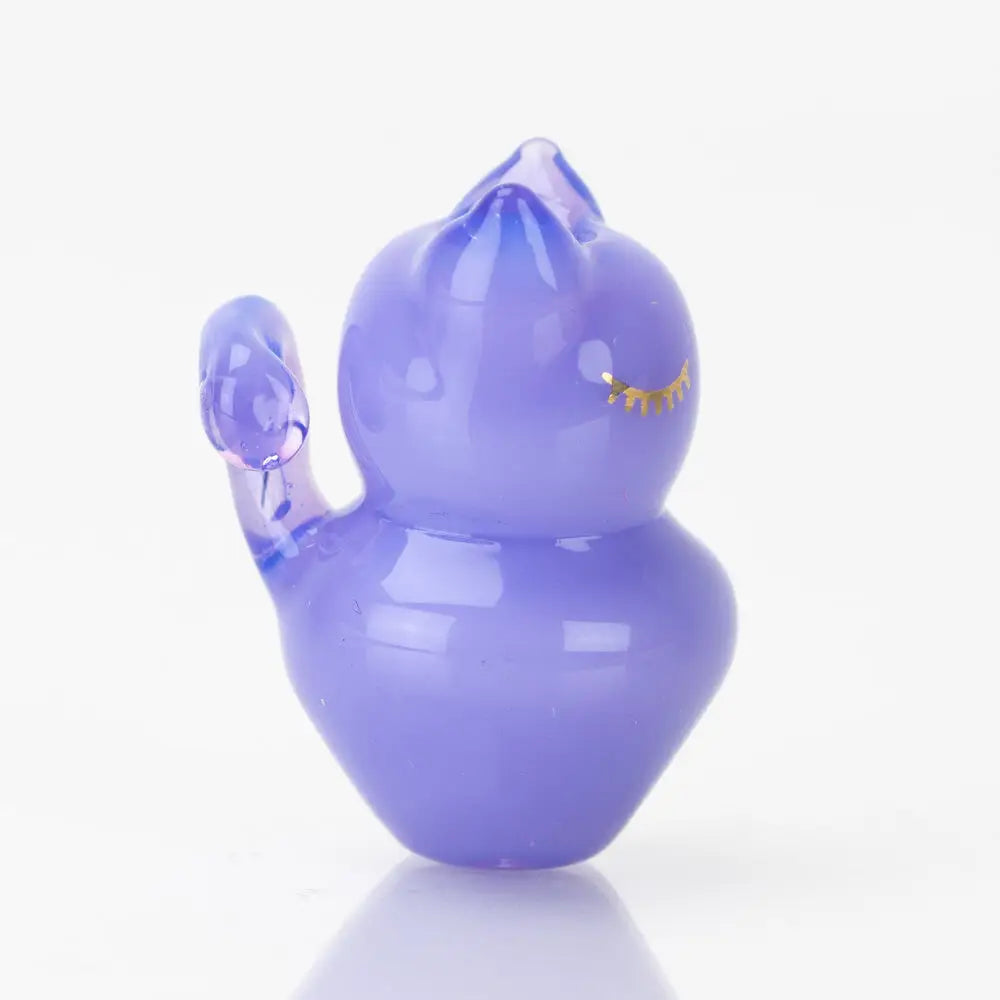 Translucent lavender Sakibomb Kitty Carb Cap figurine of sleeping cat with raised paw