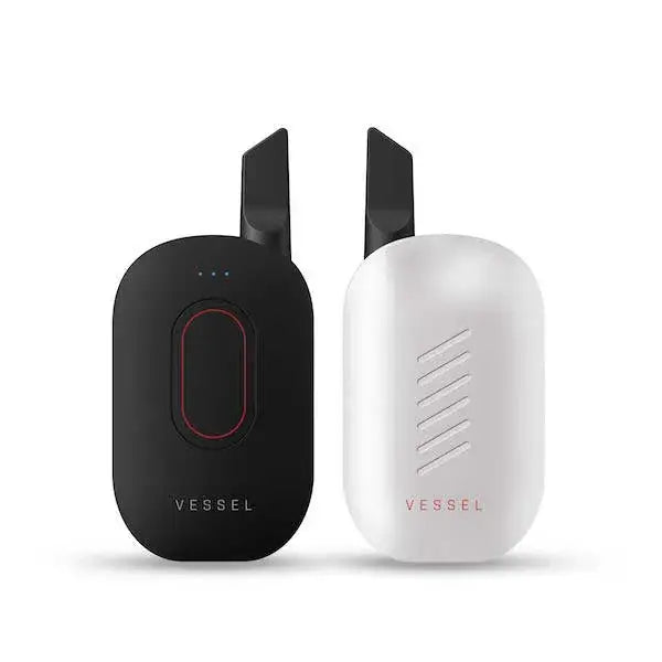 Vessel Compass cartridge battery with sleek black and white wireless charging pads