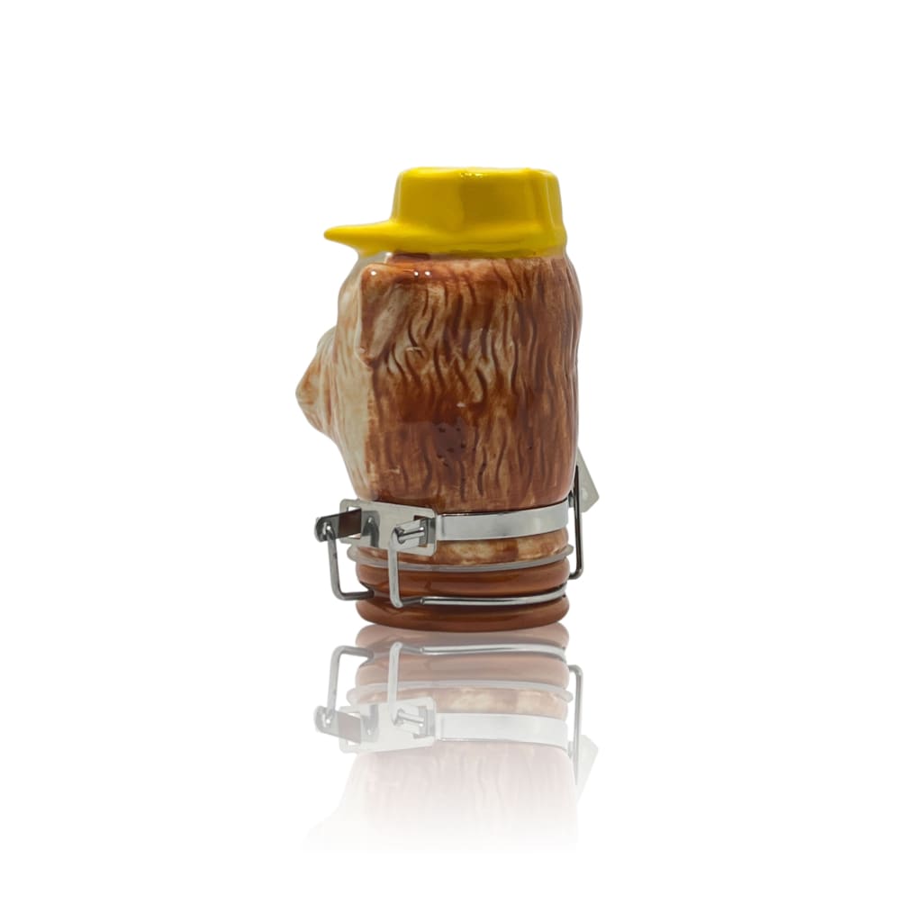 Ceramic storage jar resembling a hairy animal head with a yellow hat for elegant home decor