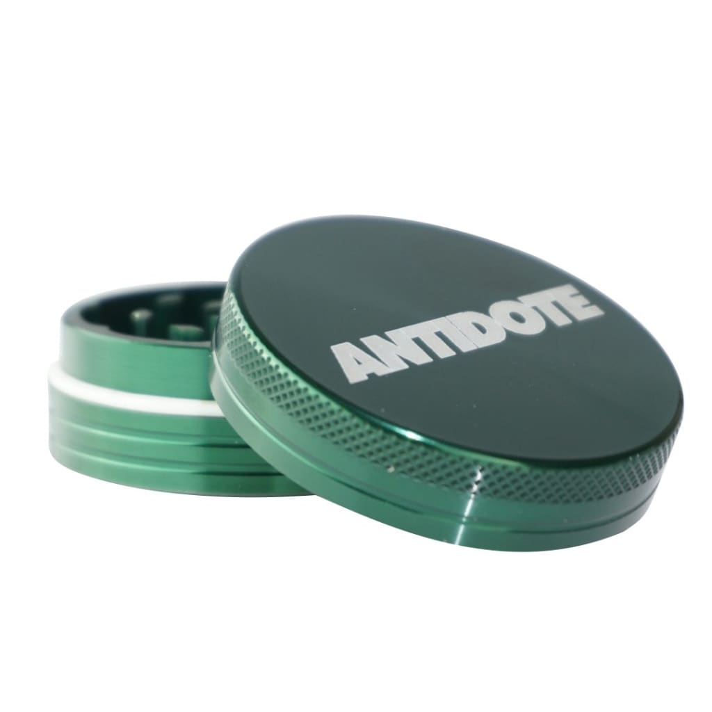 Antidote Green 2-piece metal herb grinder for efficient grinding with engraved lid