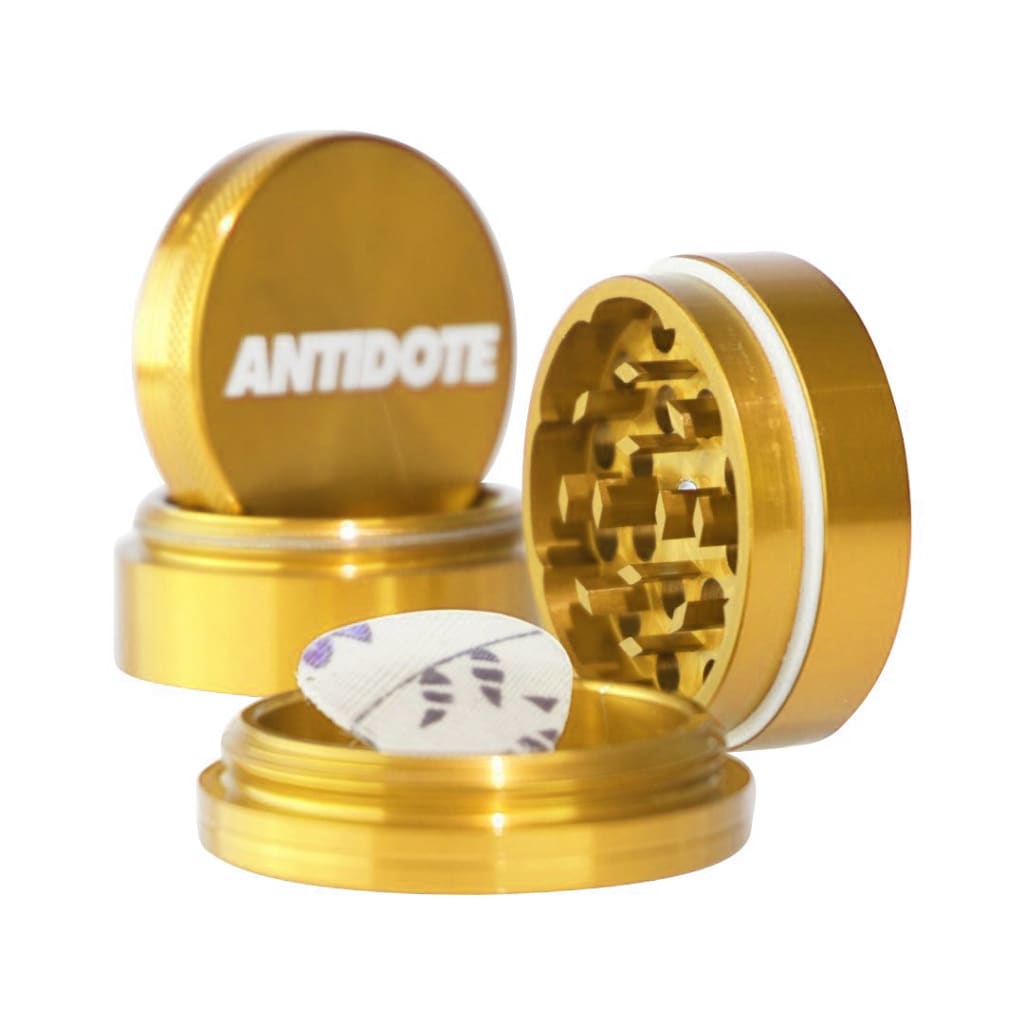 Gold-colored ANTIDOTE herb grinder in aircraft grade aluminum for premium grinding