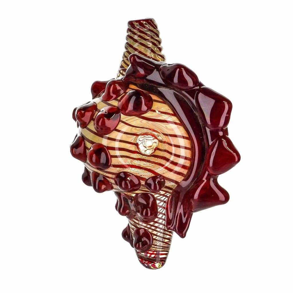 Ornate borosilicate glass conch shell pipe with swirling red and gold patterns