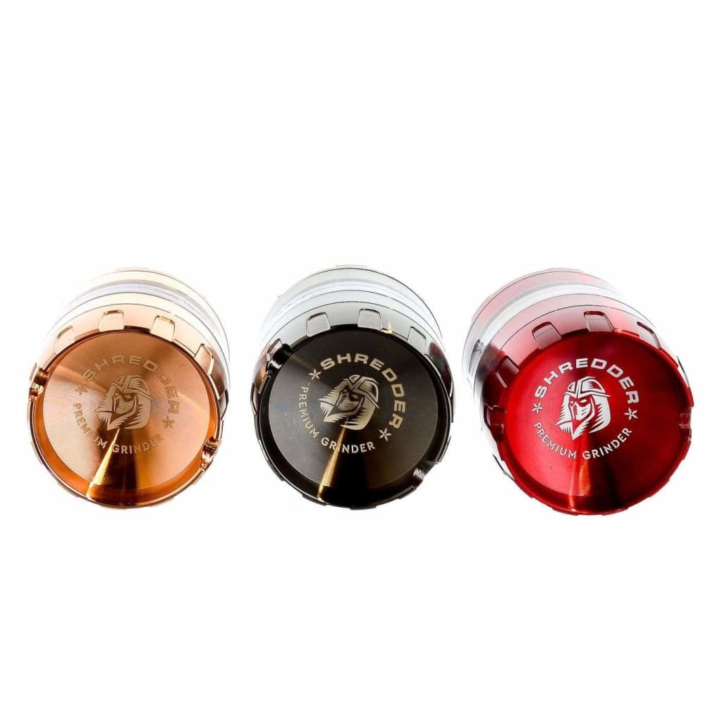Three Sharpener brand pencil sharpeners in rose gold, black, and red for the Premium Grinder