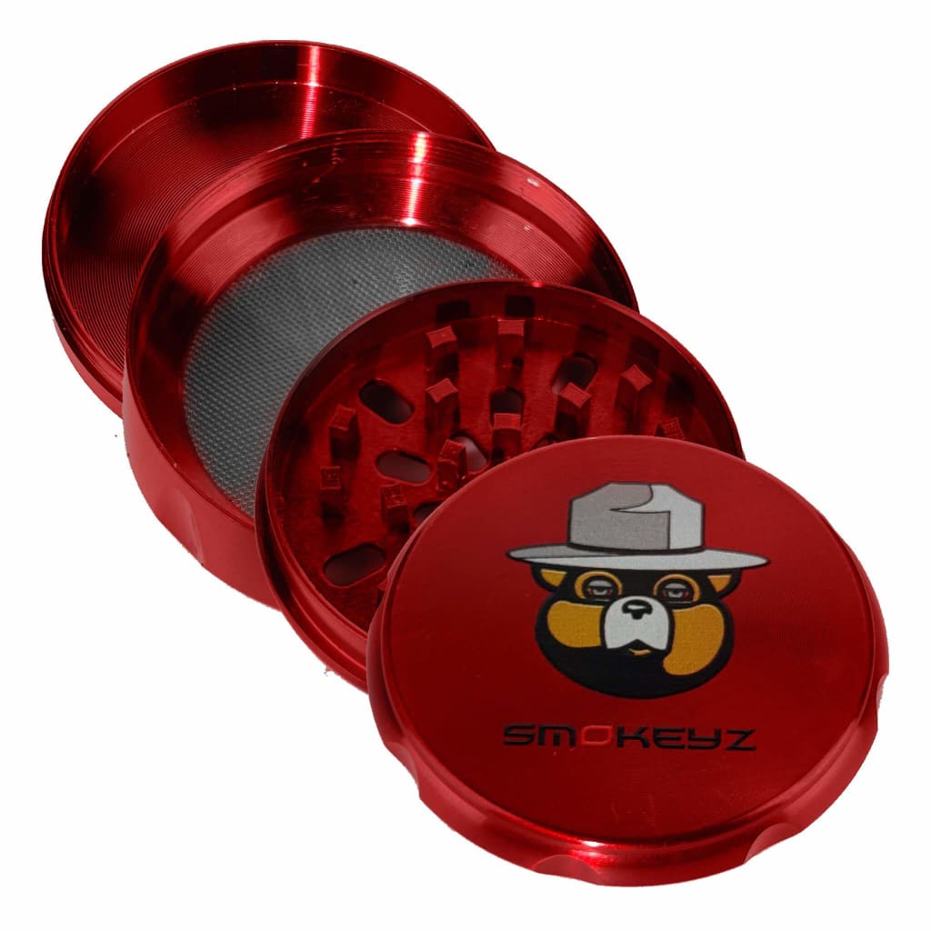 Red metal Smokey 4-part grinder with Smokeyz Bear Medallion branded lid