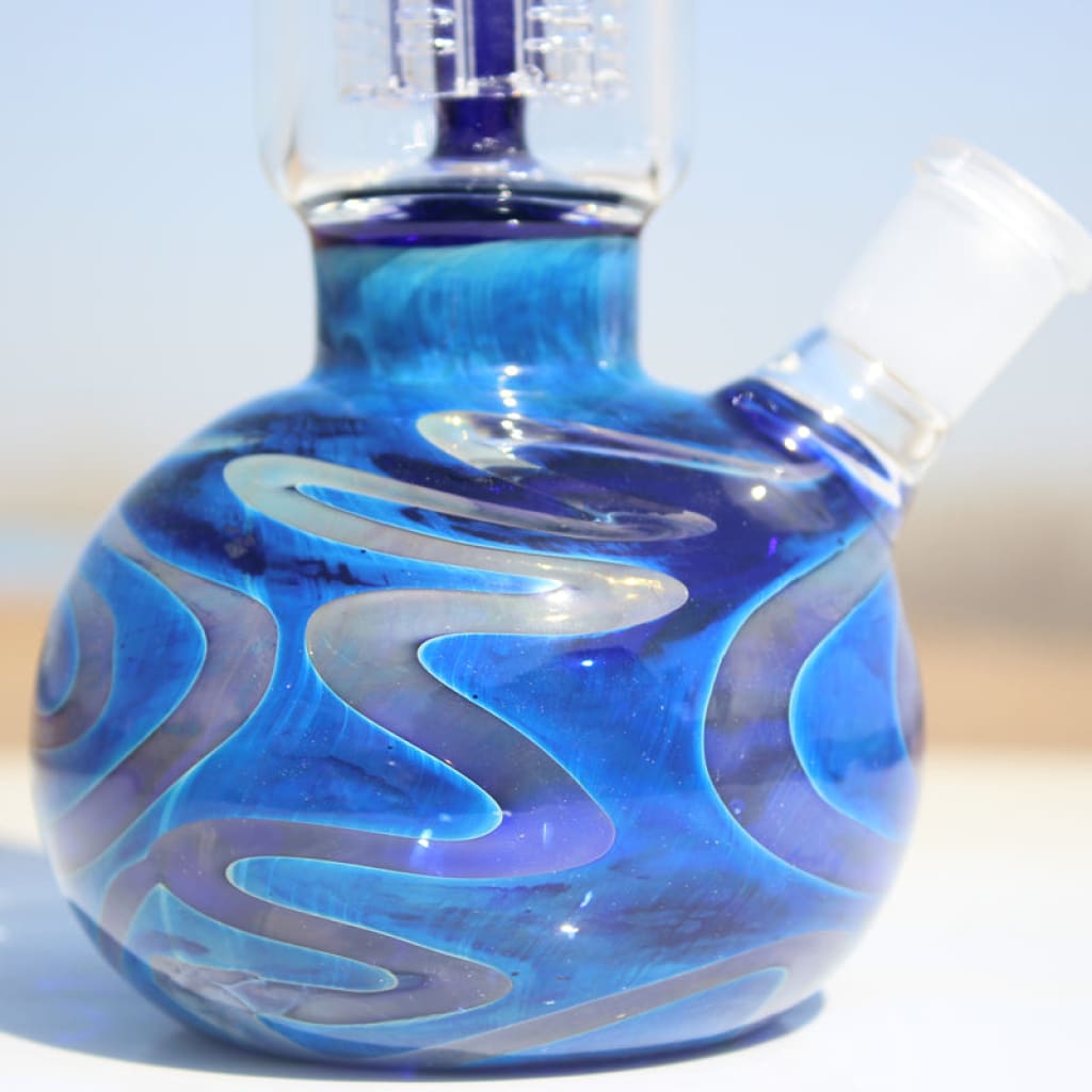 Blue glass water pipe base with swirling white patterns and Coil Perc