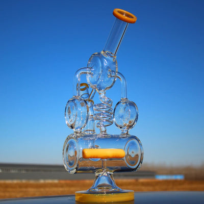 Elaborate glass bong featuring Recycler Style Inline and Spring Body Shape design