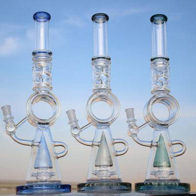 Three glass water pipes featuring circular percolators and colored bases for smooth hits