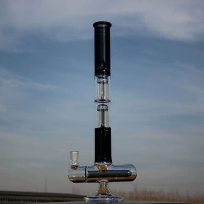 Dual arm percolated glass water pipe with metal base and tall cylindrical chamber