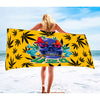 Generously sized skull beach towel featuring colorful skull and marijuana leaf design