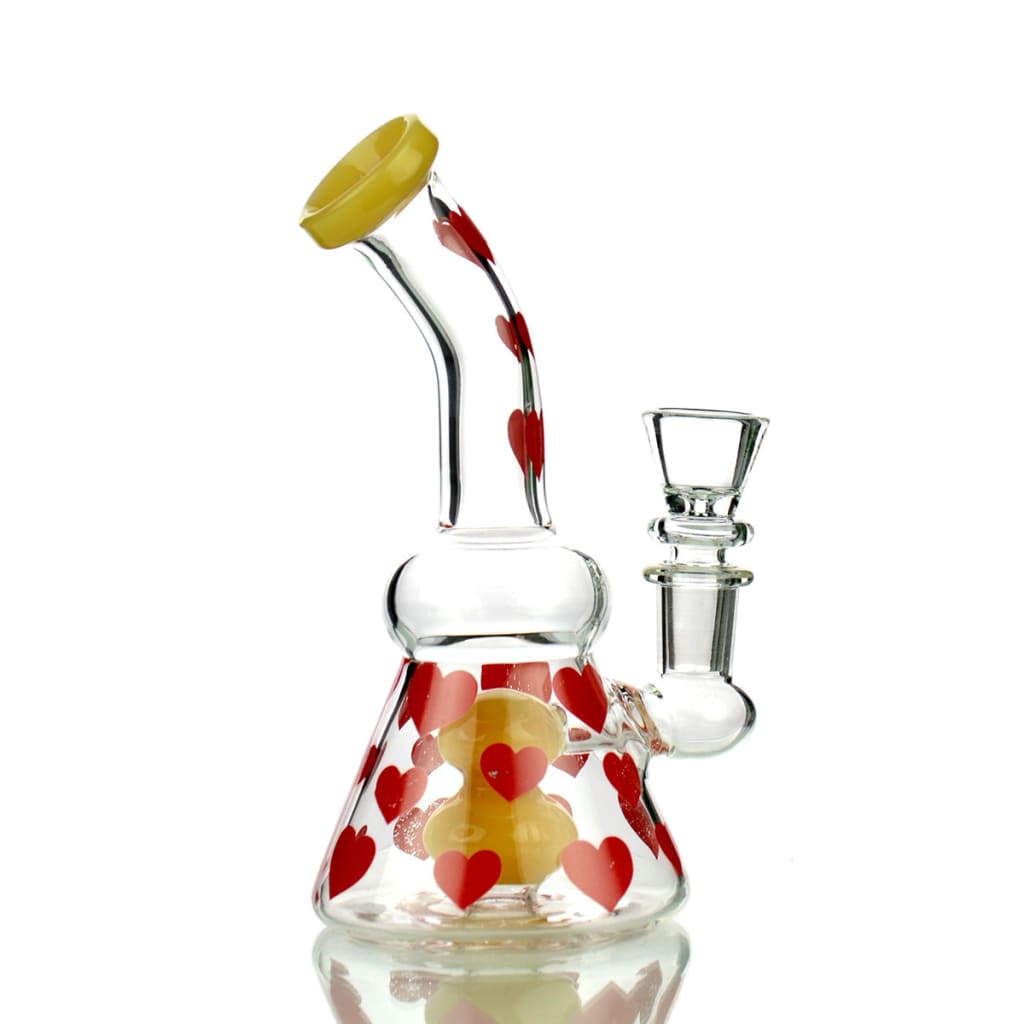 Glass water pipe with red heart patterns and yellow mouthpiece for sophisticated smokers