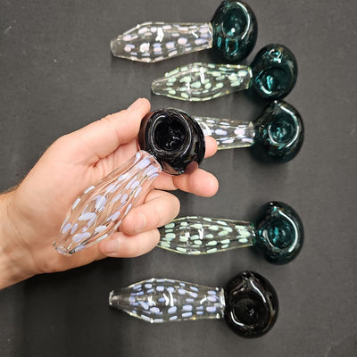 Hand holding borosilicate 6polkadot glass spoon pipe for a superior smoking experience