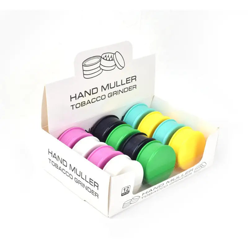 Display of 62mm Muller Plastic Grinders in Solid Colors with vibrant designs