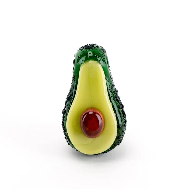 Avocadope pendant glass hand pipe by Empire Glassworks, vibrant green and yellow avocado with red gemstone pit