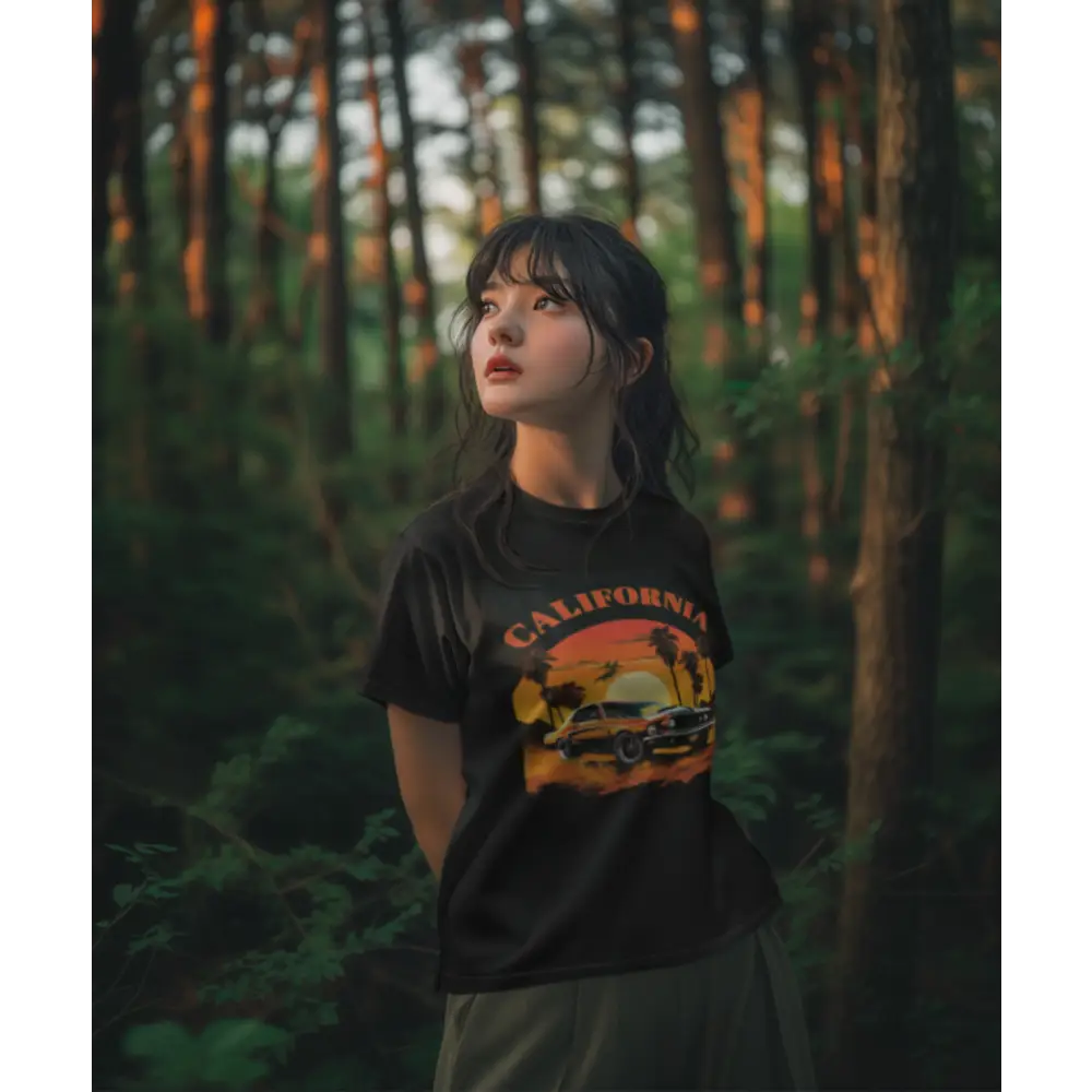 Young woman in a black California half sleeve t-shirt in a lush forest setting