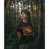 Young woman in a black California half sleeve t-shirt in a lush forest setting