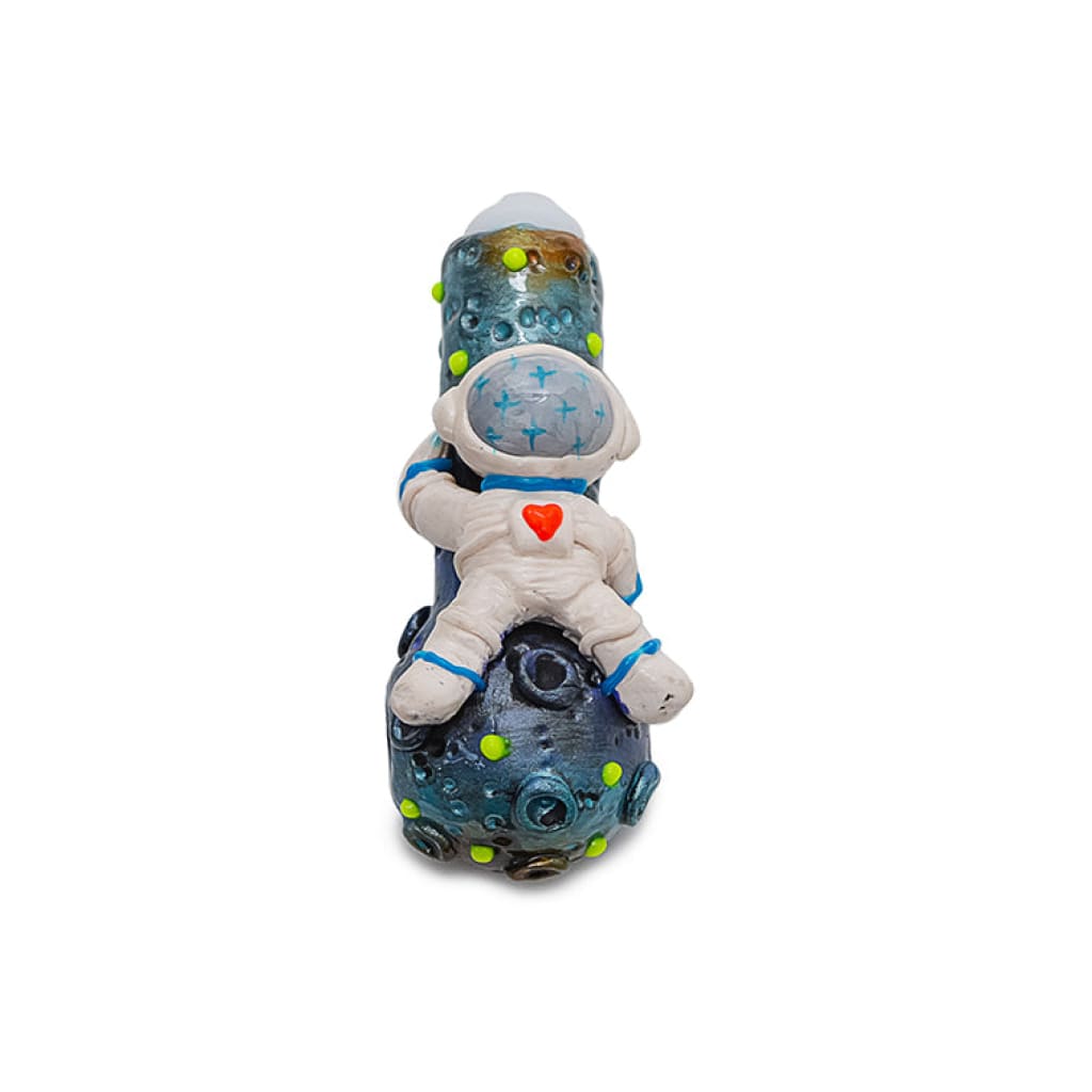 Decorative clay spaceman handpipe with cosmic design featuring a small astronaut toy