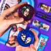 Circular compact makeup cases with colorful portraits displayed inside.