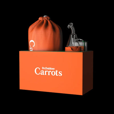 Orange box labeled Dr. Delbaar Carrots with matching bag and bottle for Anwar Carrots Dabber Boost Evo