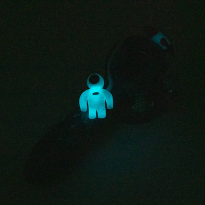 Glowing blue astronaut charm on Empire Glassworks galactic spoon pipe