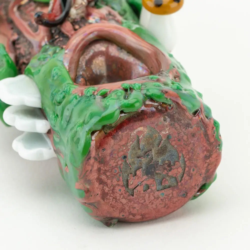 Empire Glassworks Mossy Log Hand Pipe: textured green and reddish-brown glazed ceramic figurine with white cloud-like appendages