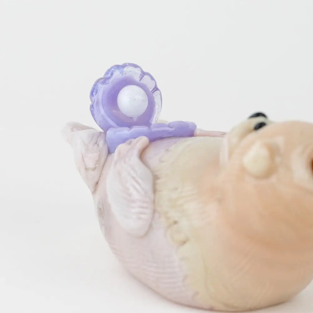 Empire Glassworks otter glass hand pipe with pink bird figurine and lavender pacifier