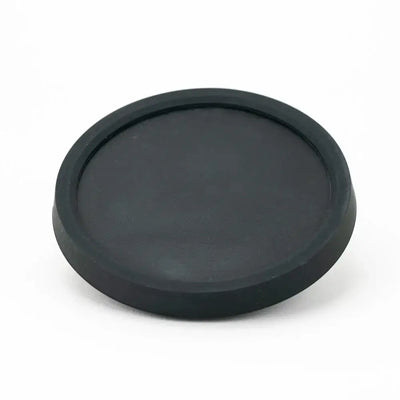 Black circular rubber lens cap on Empire Glassworks Peak Attachment Display Stand