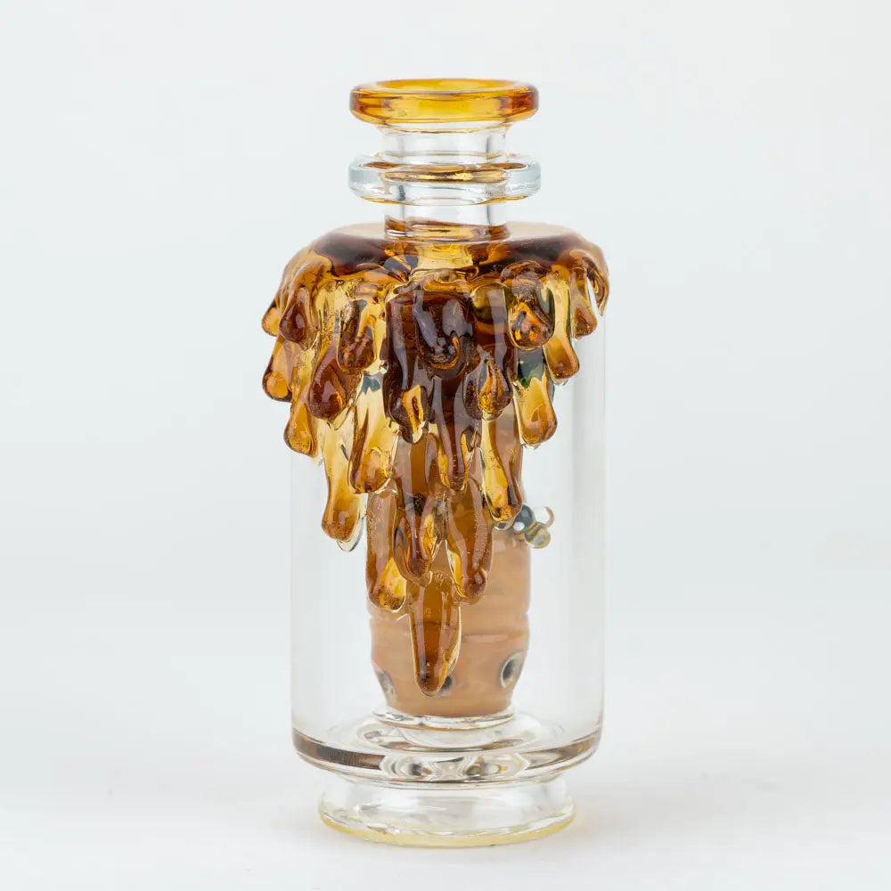Empire Glassworks Peak Attachment with amber liquid dripping artistically
