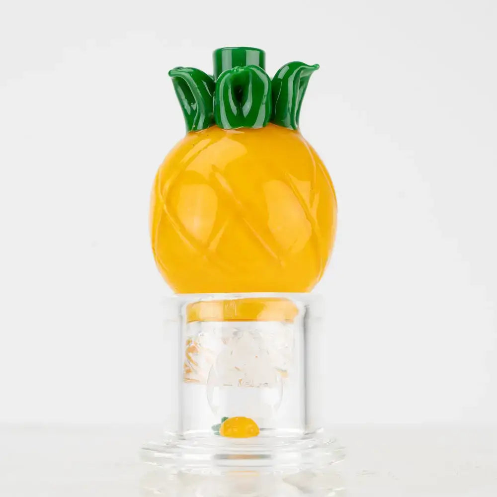 Empire Glassworks pineapple themed carb cap in vibrant yellow glass with green leafy top