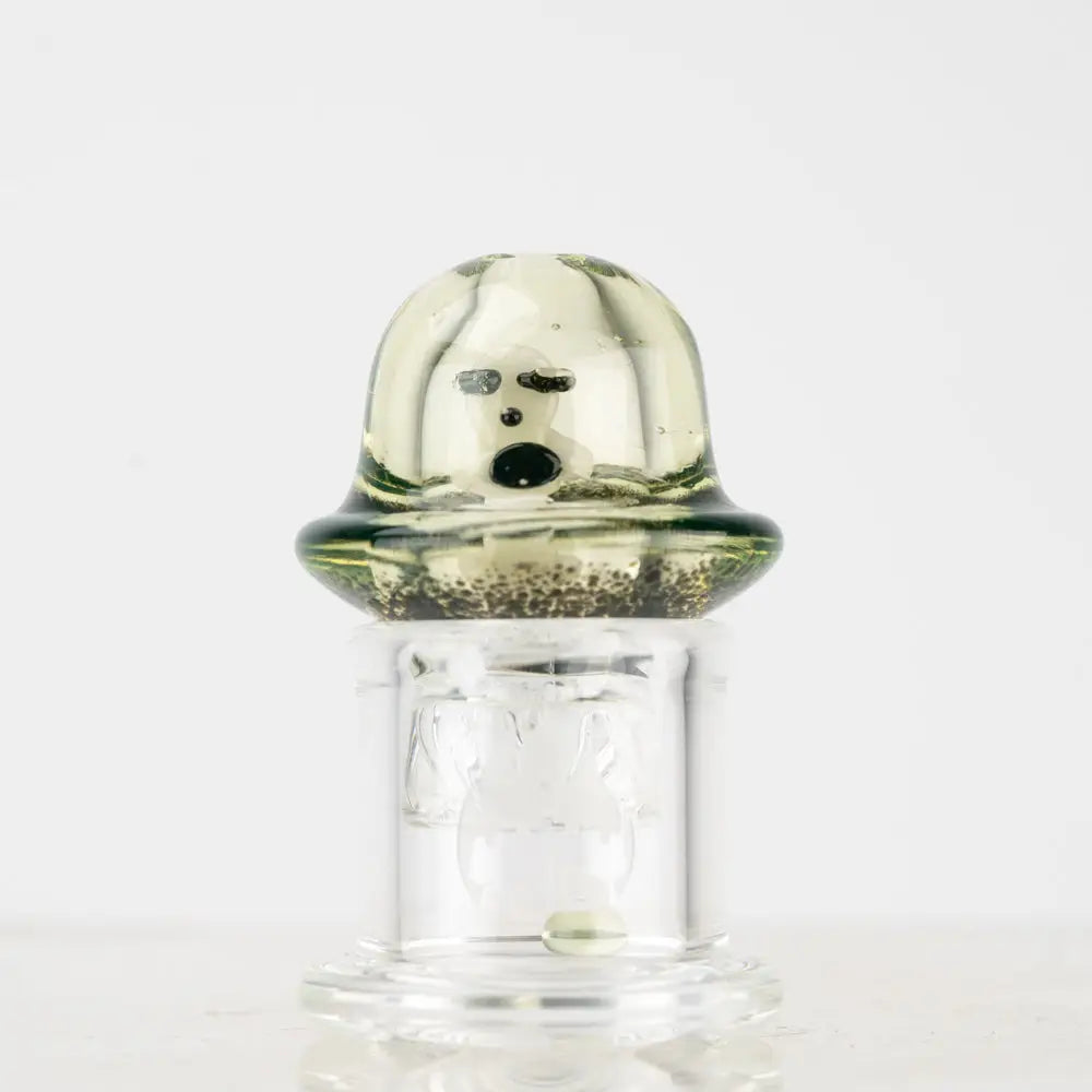 Empire Glassworks Spinner Cap Carb Cap with translucent green glass, cartoon face and speckled base