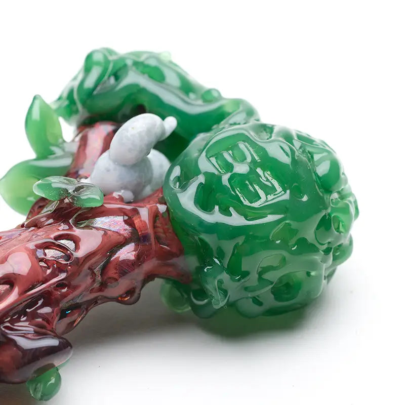 Empire Glassworks hand pipe with jade dragon carving and white snail on red branch