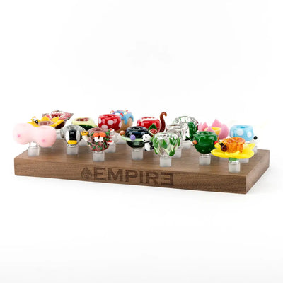 Colorful hand-blown glass bowl pieces on Empire wooden bowl piece display