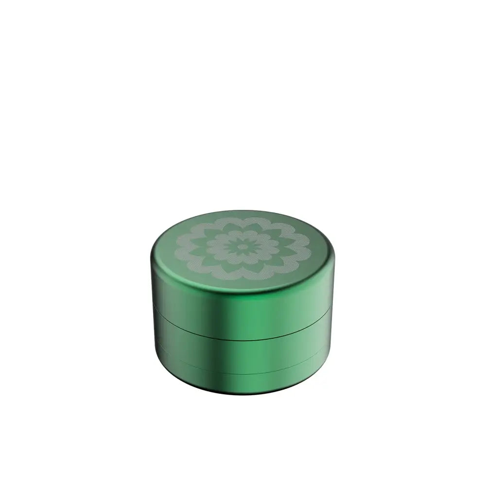 Green metal grinder featuring floral design for Flower Mill’s Generation Standard rolling paper