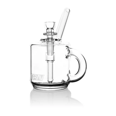 Clear glass mug-shaped water pipe used as a pocket bubbler for Grav® Coffee Mug