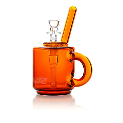 Orange glass mug-shaped bong as Grav® Coffee Mug Pocket Bubbler for an adventurous routine