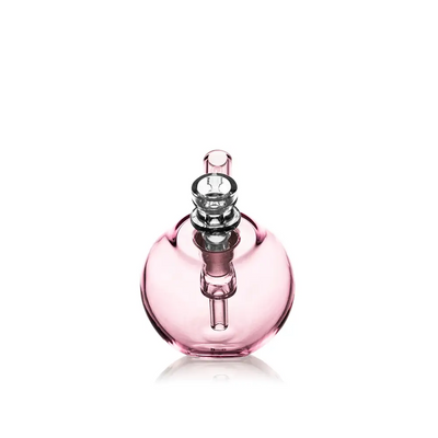 Pink glass water pipe featuring the Grav Spherical Pocket Bubbler for on-the-go use