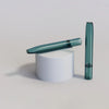 Teal-colored electronic cigarette or vaporizer next to Handcrafted Glass One-hitter Pipes - 3 Pack